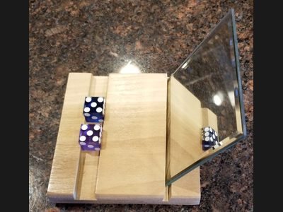 The Golden Touch Gripper — dice grip training aid for a consistent hold